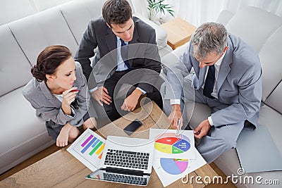 Business people analyzing diagrams together Stock Photo