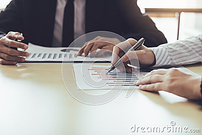 Business people analyzing finance graph document report and disc Stock Photo