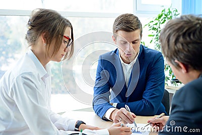 Business People Analyzing Financial Results on Graphs around the Table in Modern Office. Team Work Concept Stock Photo