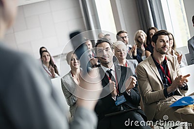 Business people applauding for public speaker during seminar Stock Photo