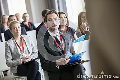 Business people attending seminar at convention center Stock Photo