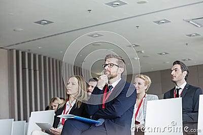 Business people attending seminar in convention center Stock Photo