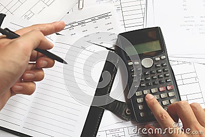 Business people counting on calculator sitting at the table. Clo Stock Photo