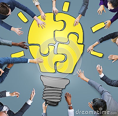 Business People Forming a Light Bulb Puzzle Stock Photo