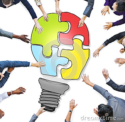 Business People Forming a Light Bulb Puzzle Stock Photo