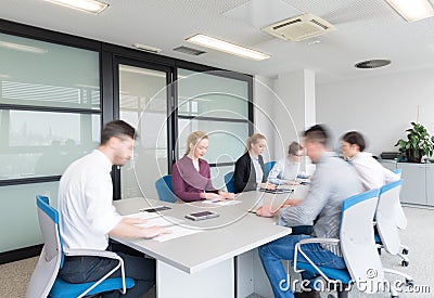 Business people group entering meeting room, motion blur Stock Photo