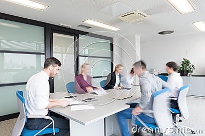 Business people group entering meeting room, motion blur Stock Photo