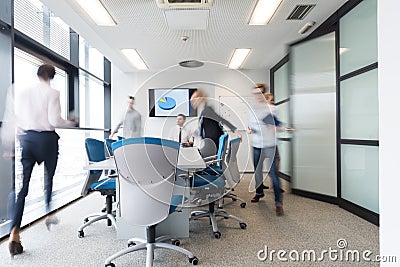 Business people group entering meeting room, motion blur Stock Photo