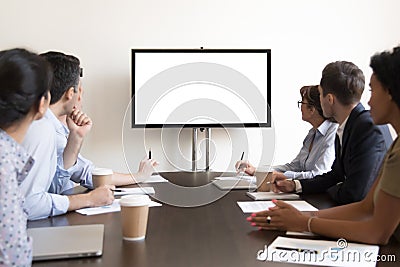 Business people group sitting at conference table looking at screen Stock Photo