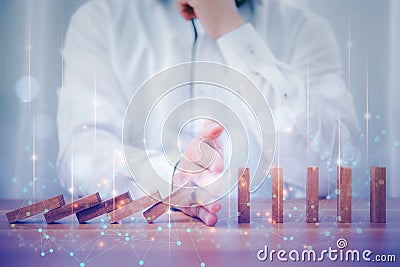 Business people hand stop falling down of wood block with digital connection line. planing and strategy business disruption Stock Photo