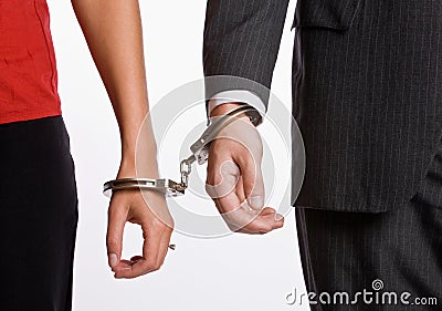 Business people handcuffed together Stock Photo