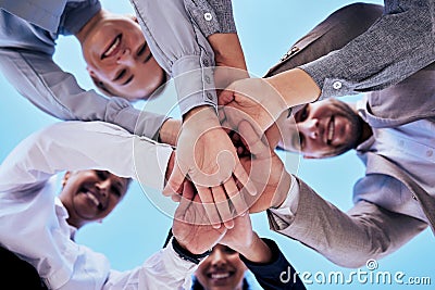 Business people, hands together and teamwork in unity below blue sky for agreement or collaboration outdoors. Group of Stock Photo