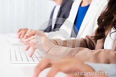Business people hands typing on computer keyboards Stock Photo