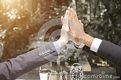 Business people happy showing team work and giving five after signing agreement or contract with foreign partners in office Stock Photo