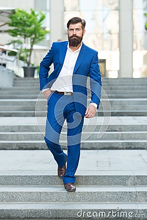 Business people. On his way to success. Walking down street. Mature hipster with beard on stairs. Bearded man in Stock Photo