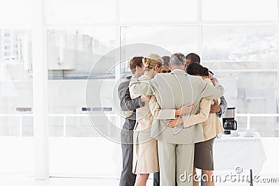 Business people hugging in a circle Stock Photo