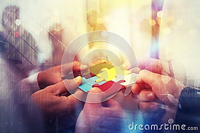 Business people join puzzle pieces in office. Concept of teamwork and partnership. double exposure with light effects Stock Photo