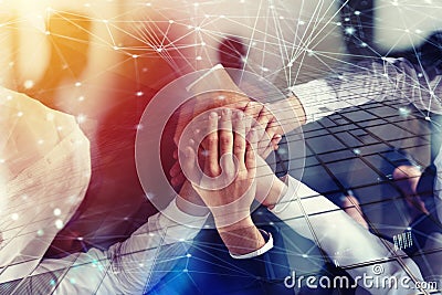 Business people joining hands in the office with network effect. concept of teamwork and partnership. double exposure Stock Photo