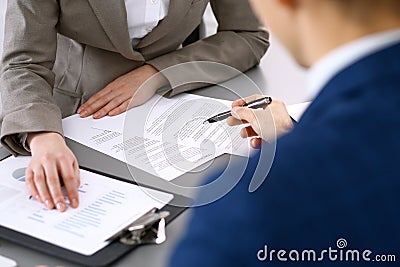 Business people and lawyer discussing contract papers sitting at the table, closeup view Stock Photo