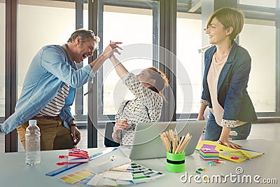 Business people in modern office celebrating good business results Stock Photo