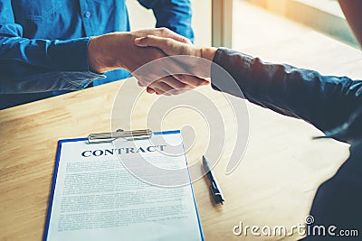 Business people negotiating a contract handshake between two col Stock Photo