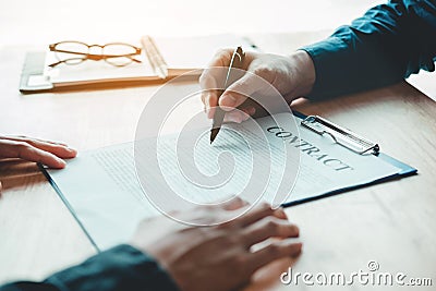 Business people negotiating a contract between two colleagues Stock Photo