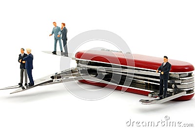 Business people on penknife Stock Photo