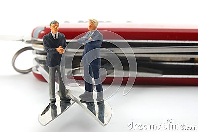 Business people on penknife Stock Photo