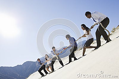 Business People Playing Tug Of War Stock Photo