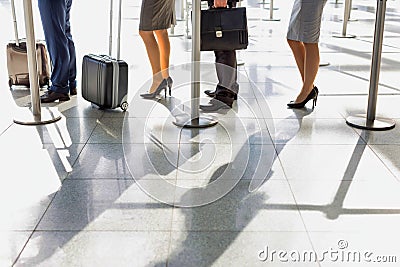 Business people queueing for check in at airport Stock Photo