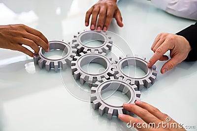 Business People`s Hand Connecting Gears Stock Photo