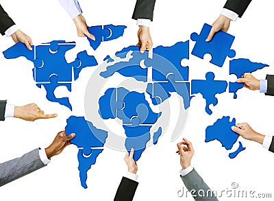 Business People's Hands with Cartography Puzzle Stock Photo