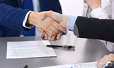 Business people shaking hands, finishing up a papers signing. Meeting, contract and lawyer consulting concept Stock Photo