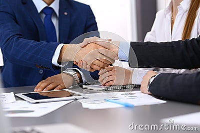 Business people shaking hands, finishing up a papers signing. Meeting, contract and lawyer consulting concept Stock Photo