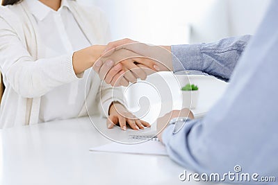 Business people shaking hands at meeting or negotiation. Businessman and woman handshake at office while sitting at the Stock Photo