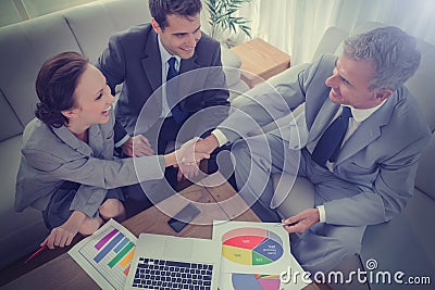 Business people shaking hands while working Stock Photo