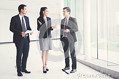 Business people talking and discussing work in building hallway Stock Photo