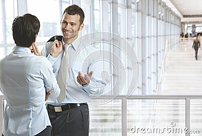 Business people talking in office lobby Stock Photo