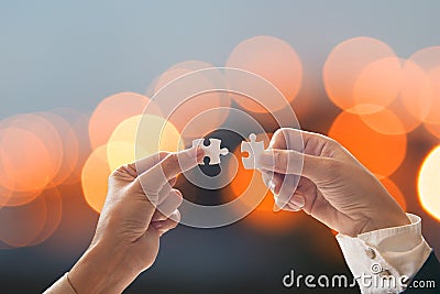 Business people team work holding two jigsaw connecting couple puzzle piece for matching to goals target, success and start up new Stock Photo