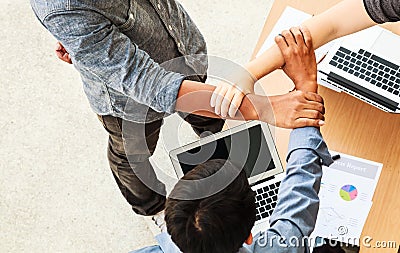 Business People Teamwork Meeting joining hands in triangle in the office concept, Using Ideas, Charts, Computers, Tablet, Smart Stock Photo