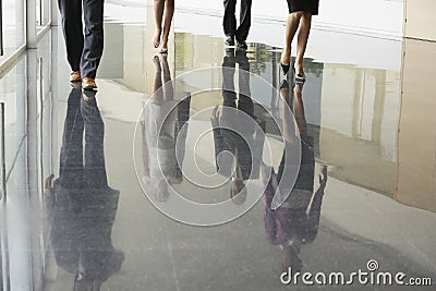 Business People Walking On Marble Flooring Stock Photo