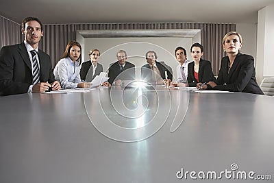 Business People Watching Presentation In Conference Room Stock Photo