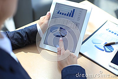 Business person analyzing financial statistics Stock Photo