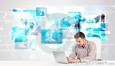 Business person at desk with modern tech images at background Stock Photo