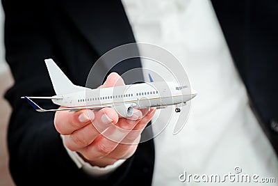 Business person holding airplane model. Transport, aircraft industry, airline Stock Photo