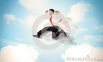 Business person jumping over clouds in the sky Stock Photo