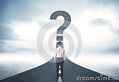 Business person lokking at road with question mark sign Stock Photo