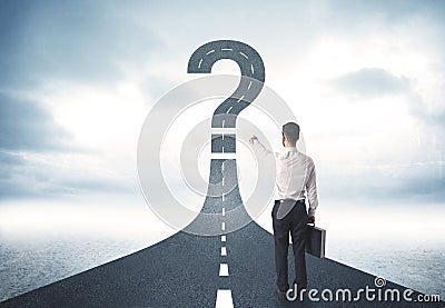 Business person lokking at road with question mark sign Stock Photo