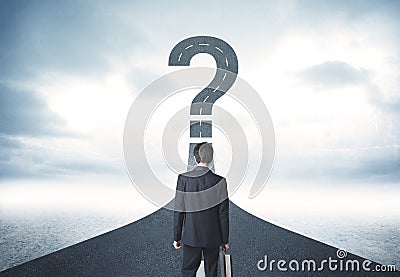 Business person lokking at road with question mark sign Stock Photo