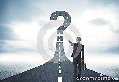 Business person lokking at road with question mark sign Stock Photo